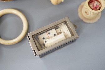 A collection of ivory objects, to include a manju netsuke, a needle box, miniature dominos, etc., 19th century